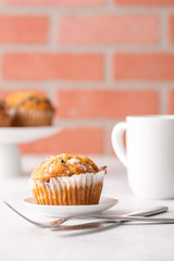 Blueberry muffins with white table place setting.