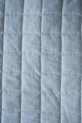 Background material. A white square pattern bed pat. white and blue.