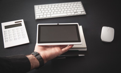 Businessman holding white digital tablet.