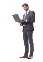 in full growth. businessman standing with open laptop