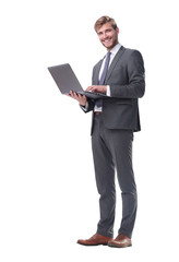 in full growth. businessman standing with open laptop