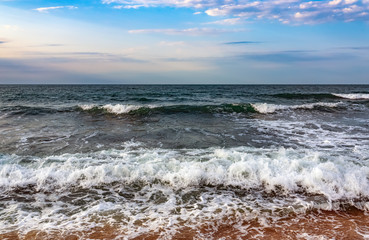 Fototapeta na wymiar Beach with a wavy beautiful sea