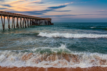 Pier at sunset, wavy beautiful sea