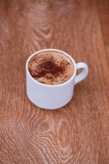 Christmas gingerbread cookies on a wooden background with aromatic coffee and cinnamon sticks