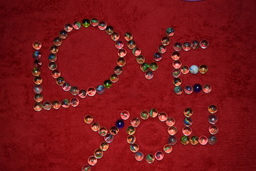 character letters from marbles with a red bakground