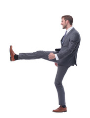 in full growth. smiling businessman pushing off the wall