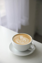 cappuccino or Latte art coffee made from milk on the wood table in coffee shop