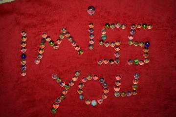 character letters from marbles with a red bakground