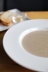 Apptetizer mushroom soup with bread on wood background