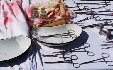 Medical instruments and blood tampons on the table after surgery. Field military hospital.