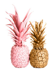 Gold and pink painted fresh pineapples on white background