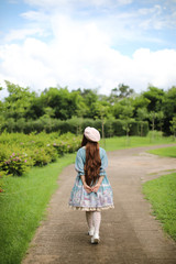 Portrait of asian girl in lolita fashion dress in garden background