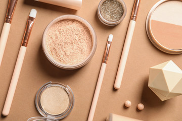 Flat lay composition with makeup brushes on brown background