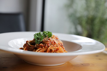 spaghetti Bolognese with minced beef and tomato sauce garnished with parmesan cheese and basil ,...