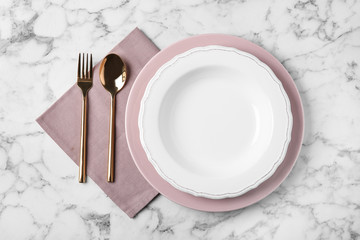 Beautiful table setting on white marble background, flat lay