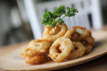 Caramari , Appetizer Crispy fried squid ring with tartar sauce on wood background traditional italian food