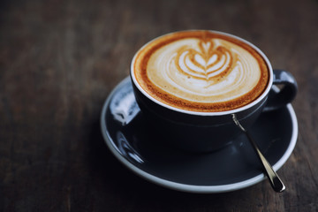 cappuccino or Latte art coffee made from milk on the wood table in coffee shop