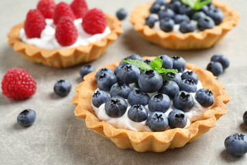 Delicious sweet pastry with berries on grey table, closeup