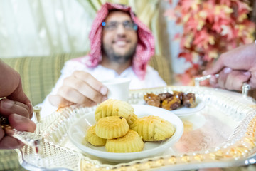 Arabic man serving coffee