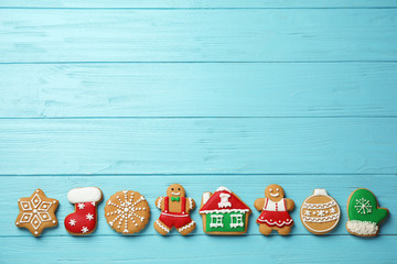 Flat lay composition with tasty homemade Christmas cookies on light blue wooden table, space for text
