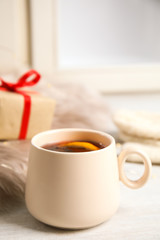 Cup of hot mulled wine on window sill. Winter drink
