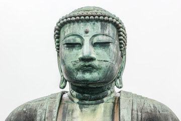 Monumental bronze statue of Amitabha Buddha. Kamakura Daibutsu on white background.