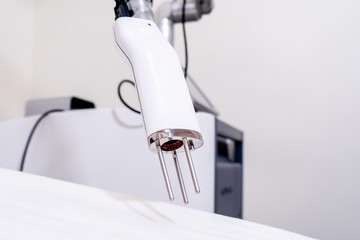Hand piece of a picosecond laser for skin pigmentation and tattoo removal treatments in a real medical laser clinic.