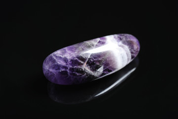 Beautiful purple amethyst chevron gemstone on black background