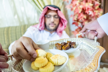 Arabic man serving coffee