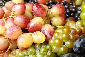 Naklejka na ściany i meble Fresh ripe juicy grapes with water drops as background, closeup