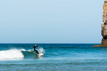 teenager surfing on the west coast of Brittany in France at Toulinguet Beach near Camaret-Sur-Mer