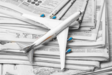 Airliner on newspaper media outlets, news concept.