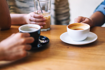 Fototapeta na wymiar Closeup image of people enjoyed drinking coffee together in cafe