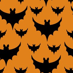 Black bats on orange background seamless Halloveen vector pattern.