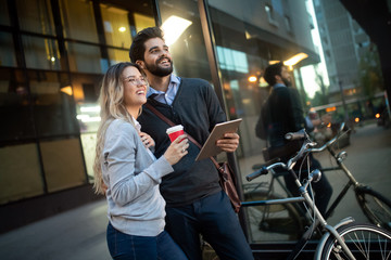 Happy young couple using a digital tablet together and smiling