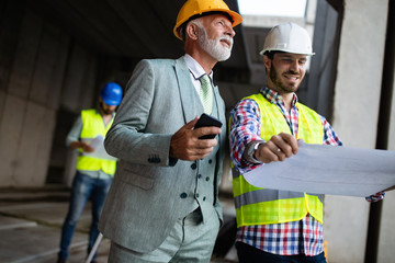 Construction engineer with foreman worker checking construction site