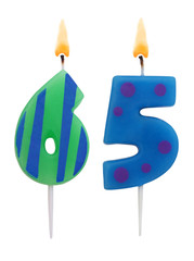 Burning birthday candles isolated on white background, number 65