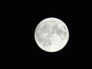 Obraz premium Genova, Italy - 09/13/2019: An amazing photography of the full moon over the city of Genova by night with a great clear sky in background and some stars