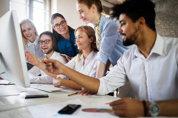 Startup business team on meeting in modern bright office interior brainstorming, working on computer