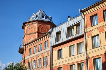 Facade of building with flats and offices and sky background