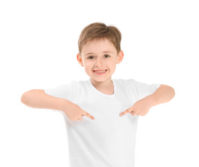 Little boy pointing at his t-shirt on white background