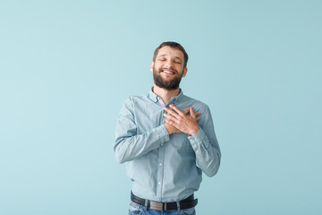 Portrait of happy young man on color background