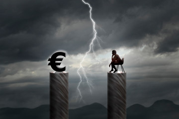 Lonely man sitting in front of the euro sign
