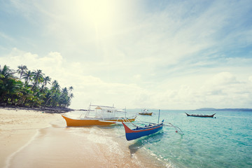Beautiful landscape with tropical white sand beach with fishing boats. Siargao Island, Philippines.