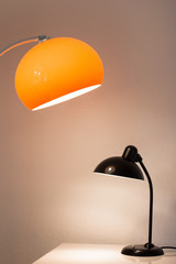 an antique black table lamp from the 20s bauhaus era standing on an old desk commode isolated on white background very rare in original condition design icon close up living room minimalistic design