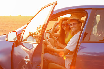 Happy couple sitting in their new car