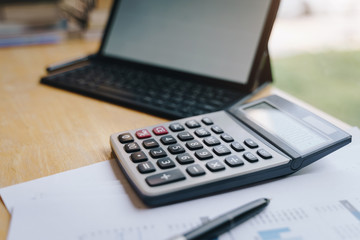  office desk table with calculator, pen and tablet.