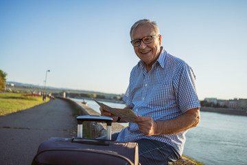 Outdoor portrait of senior man who is traveling.