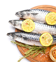 Board with raw mackerel fish and spices on white background