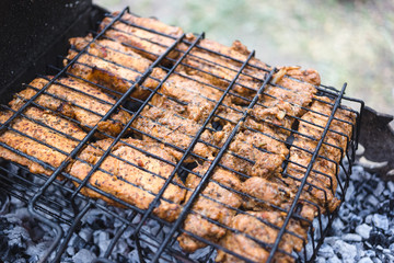 Grilled marinated chicken on a metal grid